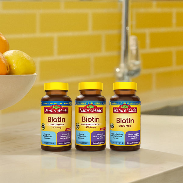 Nature Made biotin softgel supplements on kitchen counter